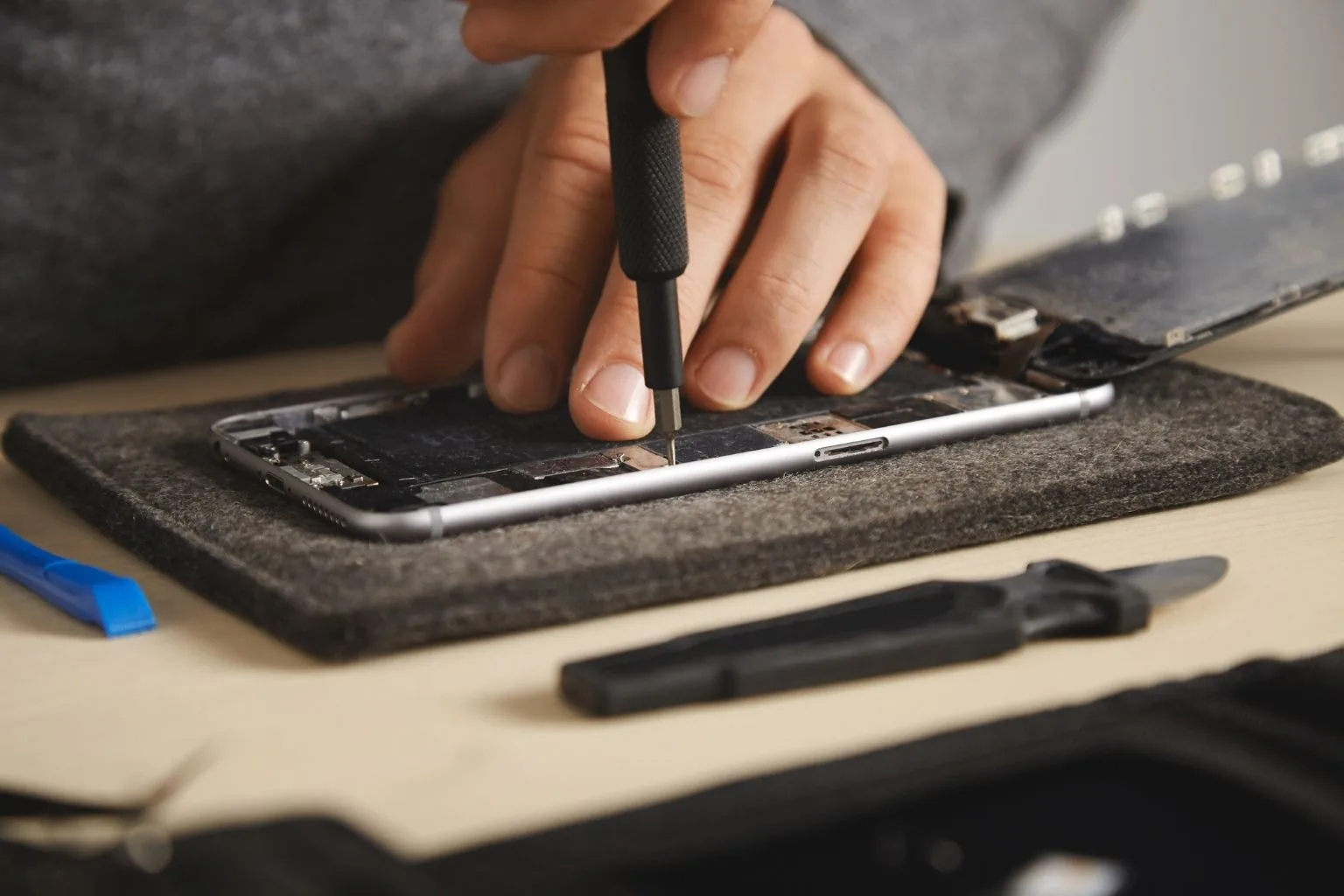 Technician replacing a cracked phone screen in Greensboro, NC