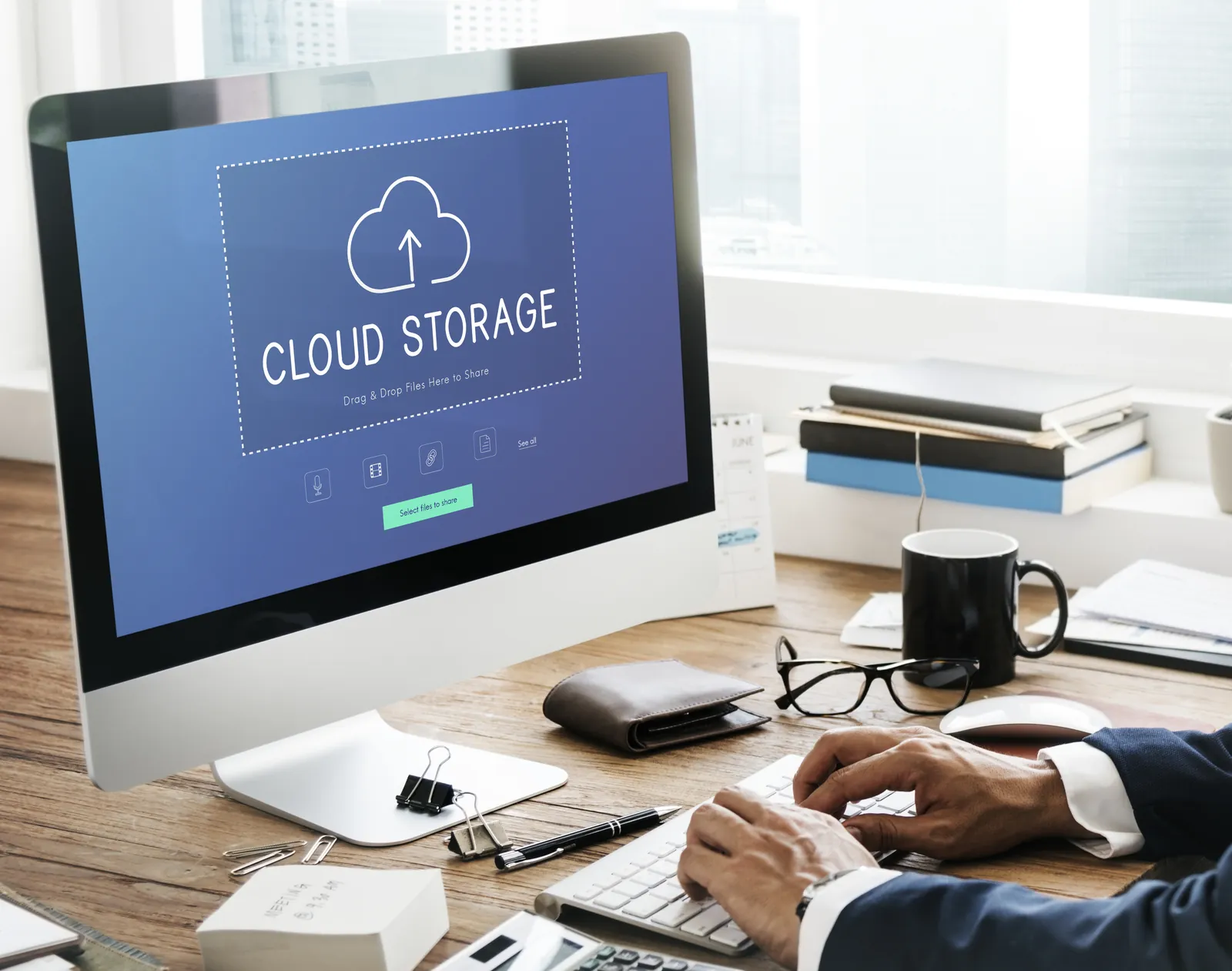 Office desktop computer showing a cloud storage upload screen