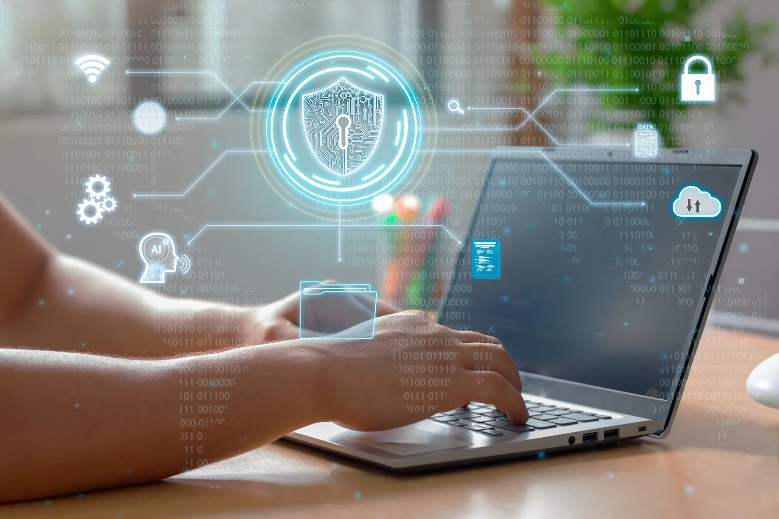 Person working on a laptop with a security shield and connected system icons