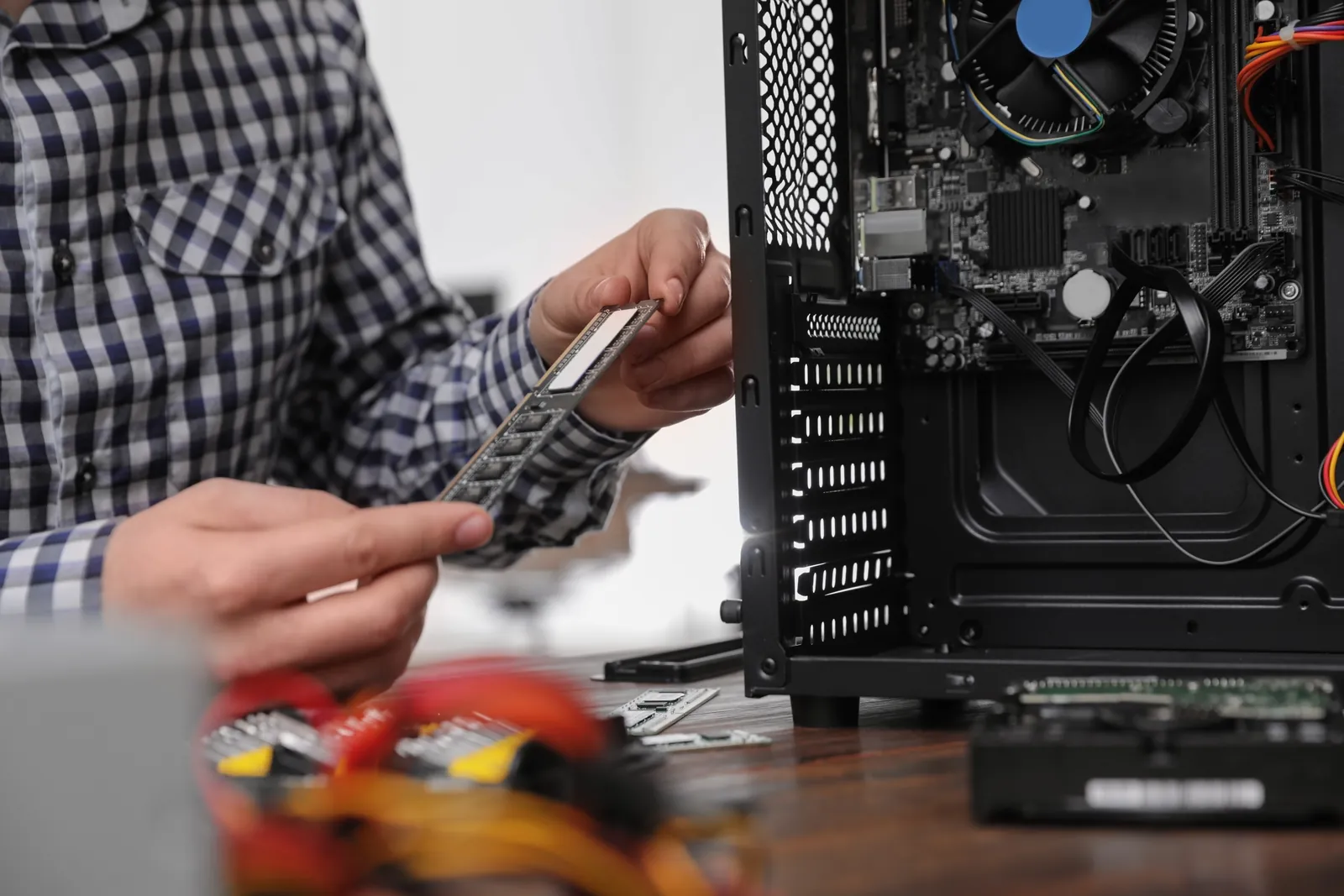 Technician installing a memory module in a desktop computer during a repair in Greensboro, NC