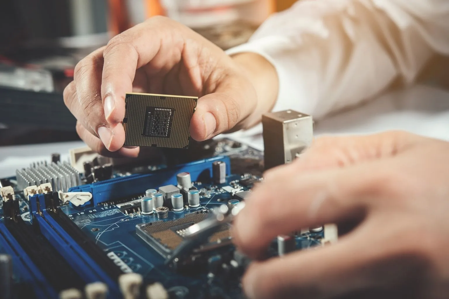 Technician repairing a laptop at a repair workbench in Greensboro, NC