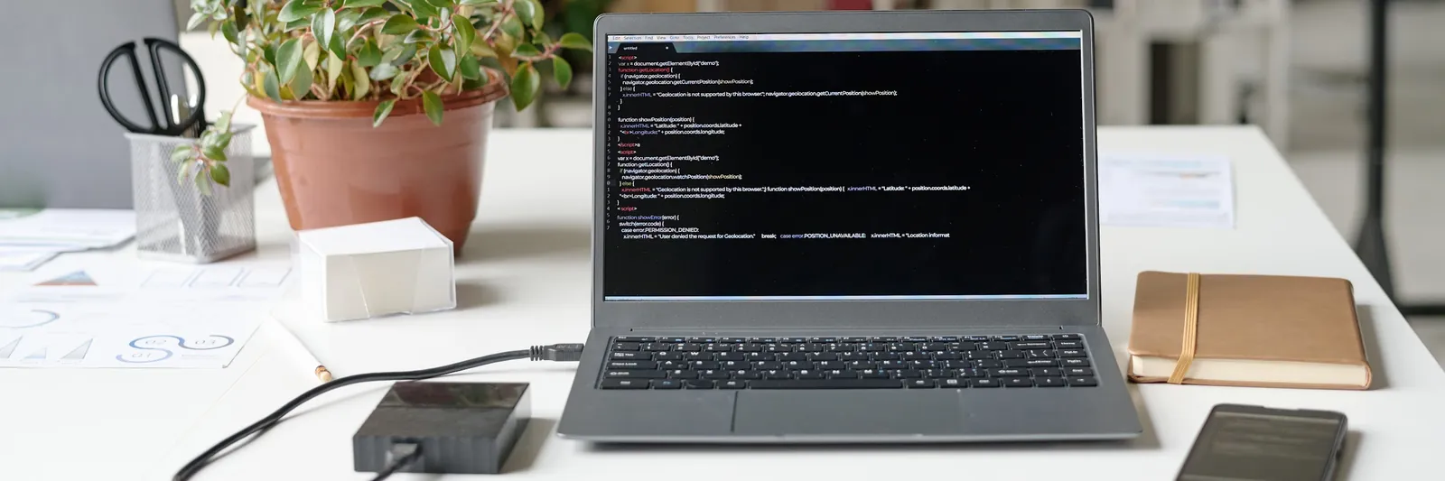 What Data Recovery Means for Your Business Laptop on an office desk running data recovery checks on a connected drive