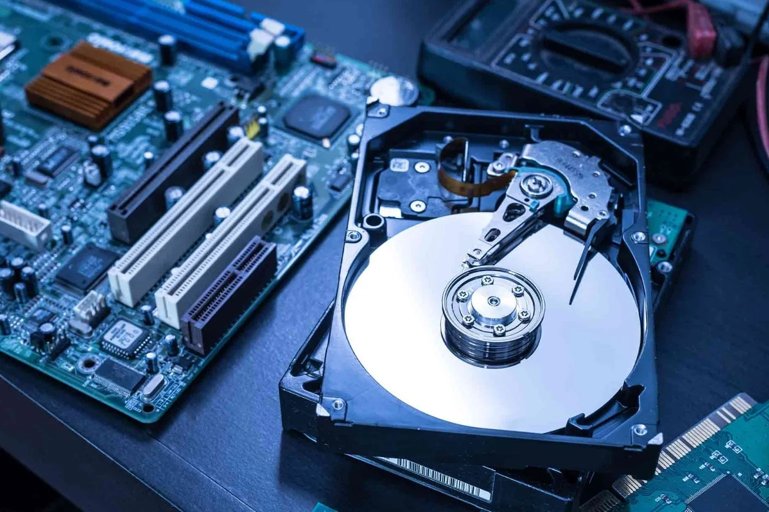 Technician examining a failed hard drive for data recovery in Greensboro, NC