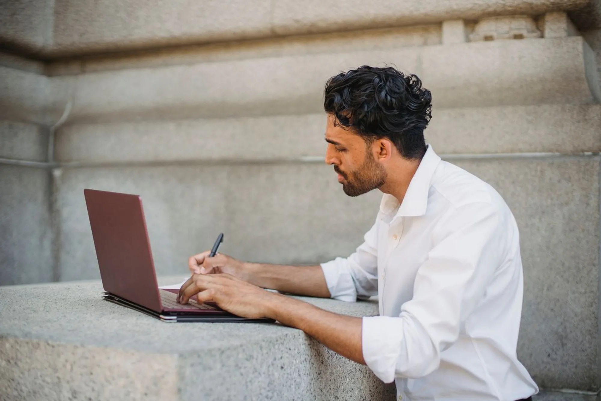 Business owner working on a laptop to manage digital marketing for a Greensboro, NC company
