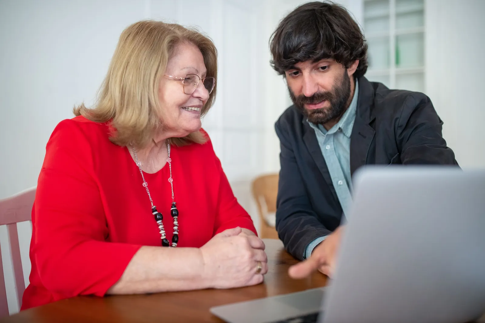 Consultant showing a client something on a laptop during a meeting
