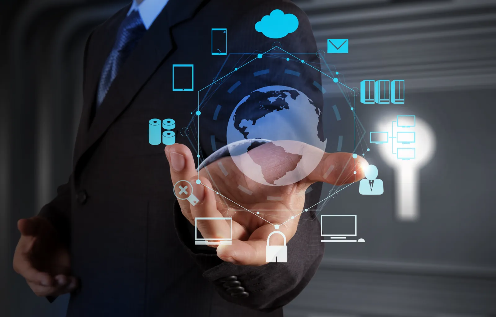 Business person holding connected cloud, device and security icons showing broad IT coverage