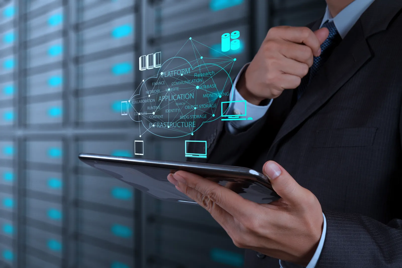 Business person with a tablet in a server room showing network and application icons