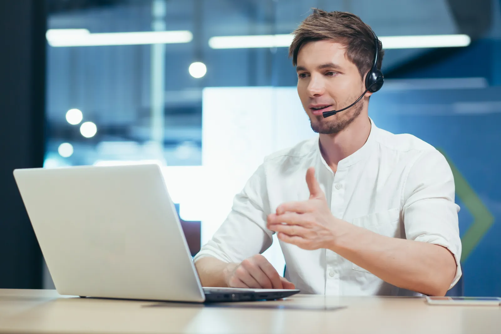 IT support technician with a headset helping a client over a video call