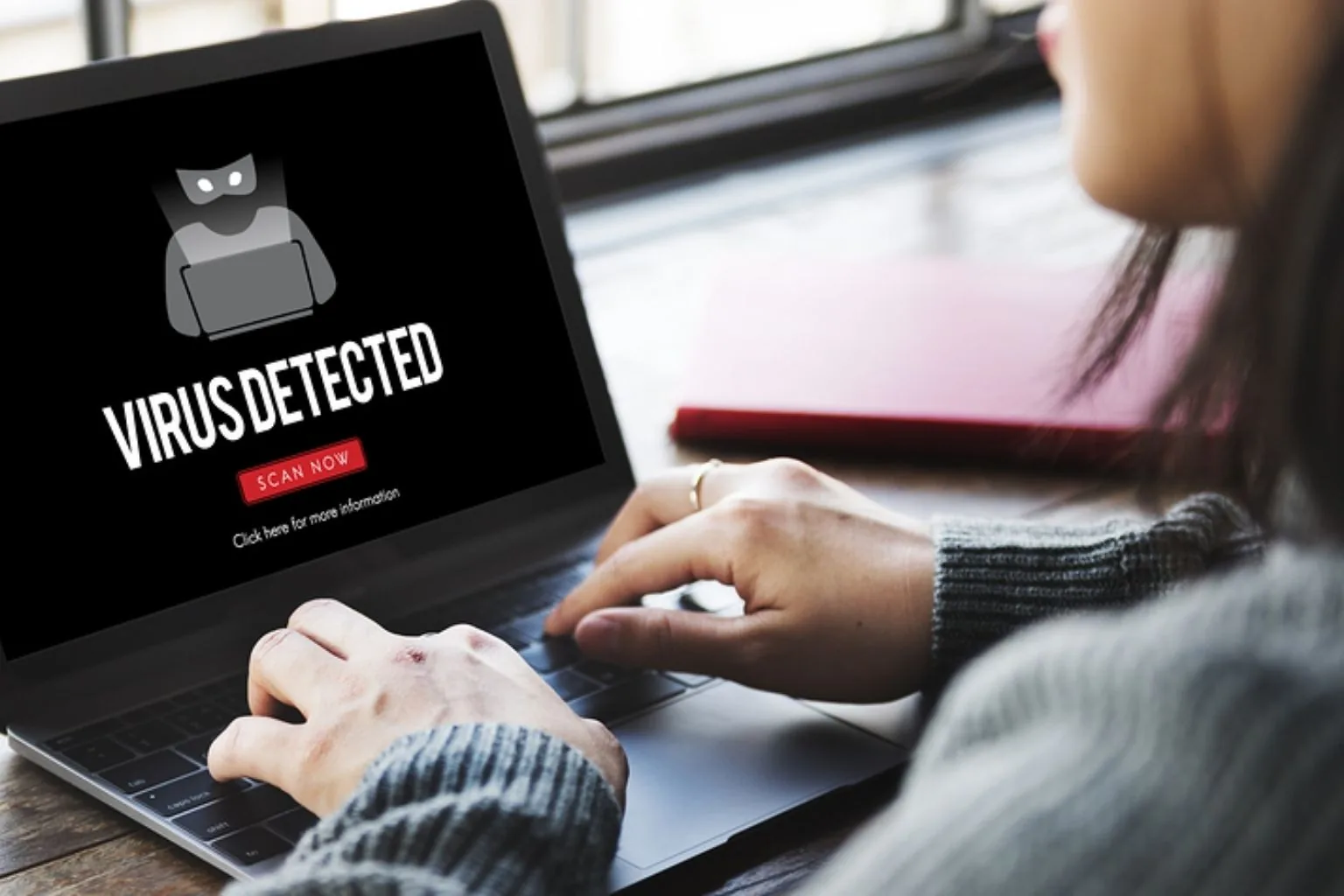 Laptop screen showing a virus detected warning during malware removal